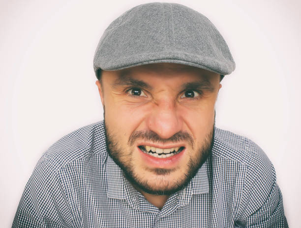 istock Dude in a cap looks suspiciously. 1080723458