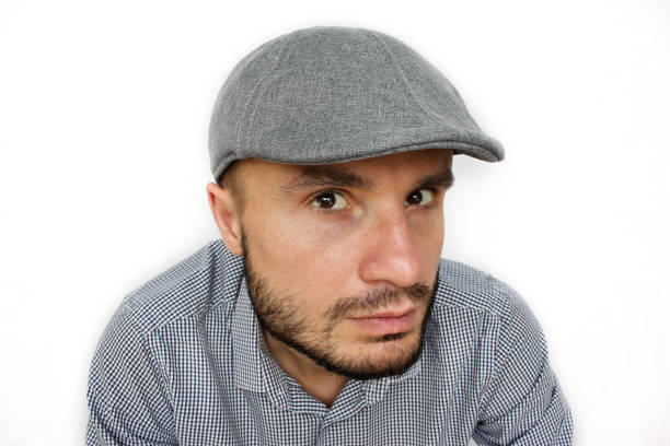 istock Dude in a cap looks suspiciously. 1080723670