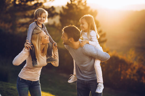 istock Young playful family having fun in the park at sunset. 1080723708