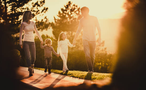 istock Happy family communicating while taking a walk at sunset. 1080725186