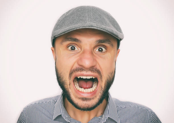 istock Dude in a cap looks suspiciously. 1080729354