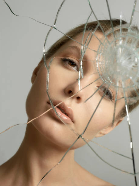 istock beautiful blonde woman reflected in a broken mirror 1080734118