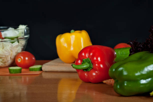istock Vegetables on a wooden table on a black background. Clean colored vegetables on the kitchen table. 1080738312