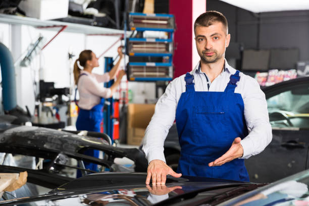 istock Mechanic demonstrating repainted car 1080740524