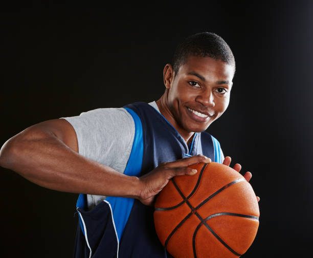 istock Smiling young basketball player preparing to dribble ball 1080740878