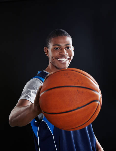 istock Smiling young basketball player with ball 1080741486