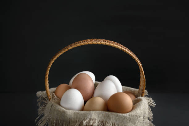 istock eggs in a birch-bark basket and a linen cloth on a dark background 1080741584