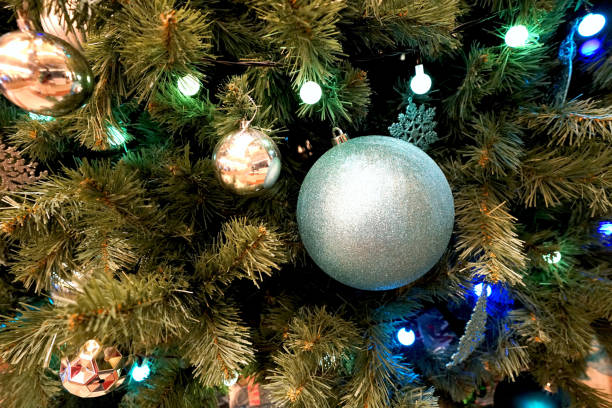 istock christmas tree and small and decoration with gold lighting 1080744918