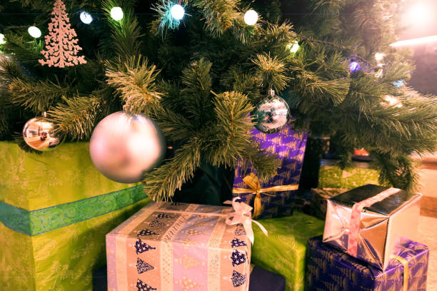 istock christmas tree and small and decoration with many gift box in  light effect background 1080744926