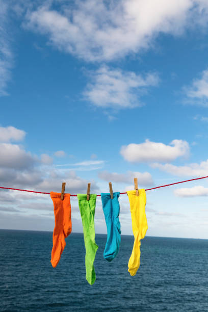 istock Bright multi-coloured socks on a washing line overlooking the sea. 1080746774