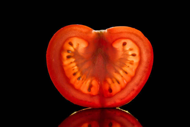 wooden mannequin rolls a tomato - healthy diet