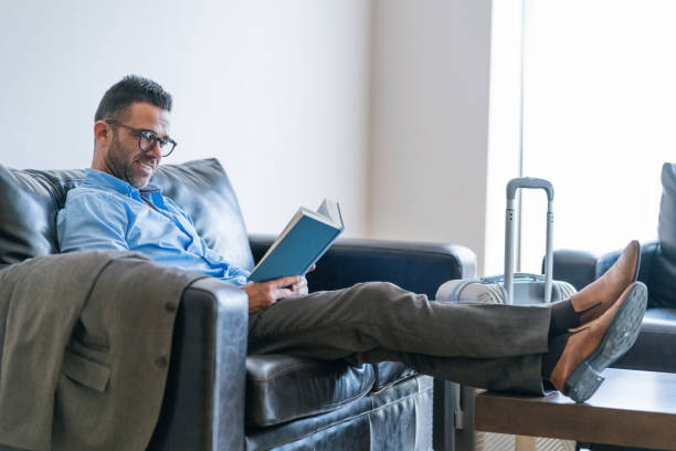 istock Businessman reading book at waiting room 1080754194