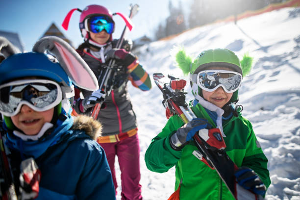 istock Children carrying skis on a winter day 1080755270