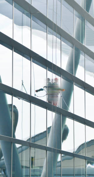 istock Dustman cleaning the glass wall 1080758140