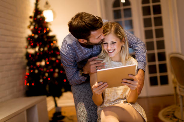 istock Handsome young couple with tablet at New Years eve 1080760040