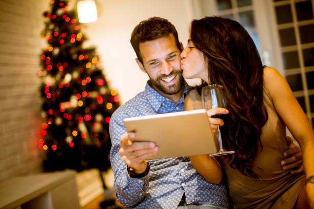 istock Handsome young couple with tablet at New Years eve 1080760070