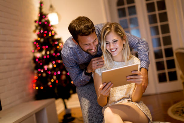 istock Handsome young couple with tablet at New Years eve 1080760084