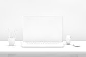 Laptop with blank screen on desk with white background