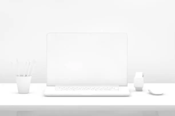 Photo of Laptop with blank screen on desk with white background