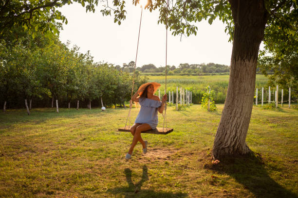 istock Beautiful woman enjoying on a swing 1080761620