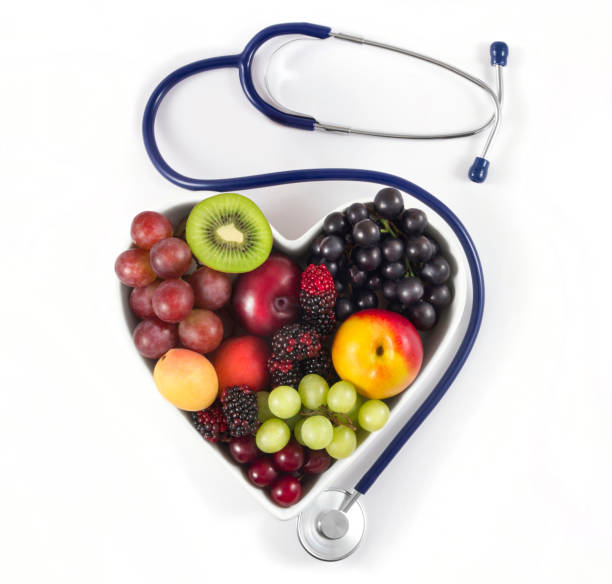 istock Fresh Fruits in Heart Shaped Bowl with Blue Stethoscope 1080766292