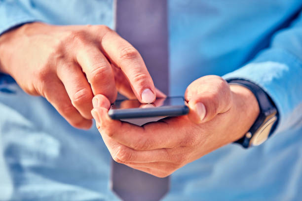 istock Businessman using his smartphone on the street. 1080777962