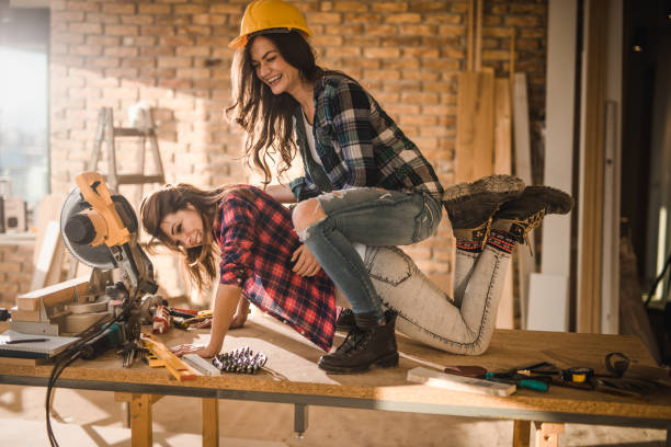 istock Cheerful female workers having fun on the table at construction site. 1080778280