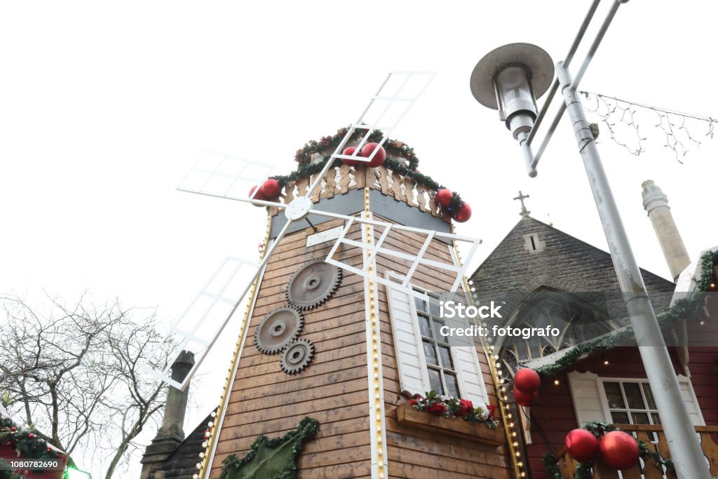 A mill stand at the Christmas Markets in the pedestrian Working Street next to Saint John the Baptist Church in Cardiff, United Kingdom Cardiff - Wales Stock Photo