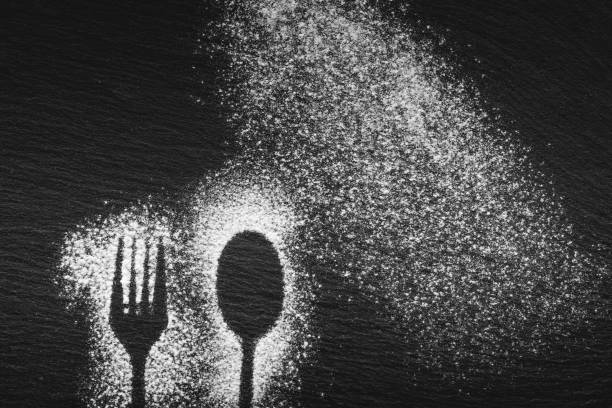 istock Silhouette of a fork and a spoon drawn with white flour 1080787964