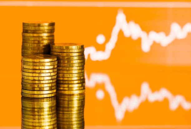 istock gold money. Fluctuating graph on red backgound. 1080788836