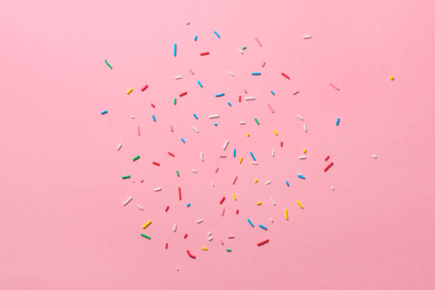istock beautiful sugar colorful sprinkles over pink background 1080795596