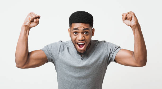African-american man screaming and showing biceps at camera