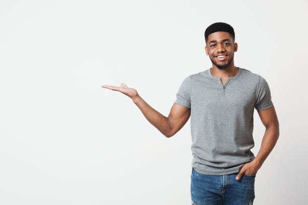 Smiling man with his palm up on white background