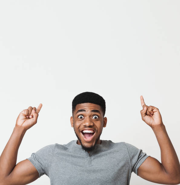 istock Excited african-american man pointing upwards at copy space 1080802078