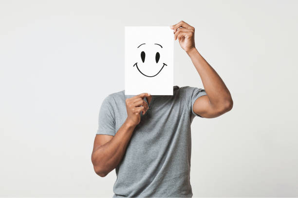 istock Black man holding paper with smiley face 1080802100