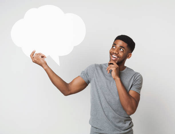 istock African-american man holding blank speech bubble on white 1080802148