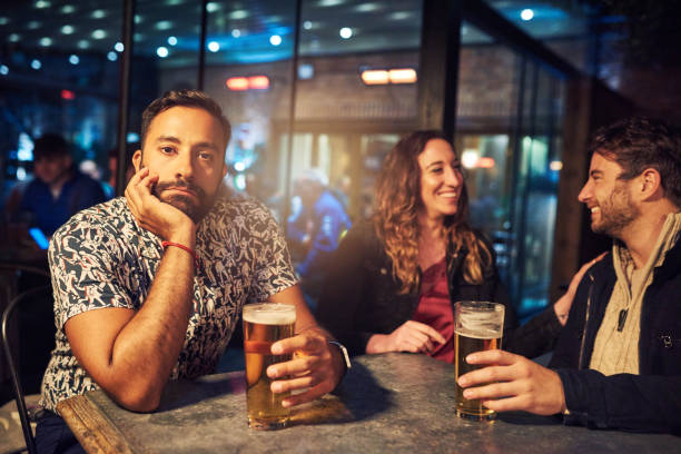 I'm bored of being the third wheel Cropped shot of a young friends at a nightclub vex nightclub stock pictures, royalty-free photos & images