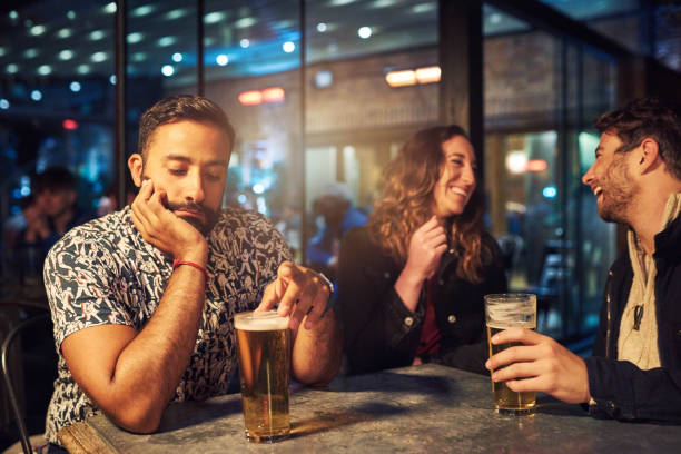 I don't like being the third wheel Cropped shot of a young couple ignoring their friend at a nightclub vex nightclub stock pictures, royalty-free photos & images