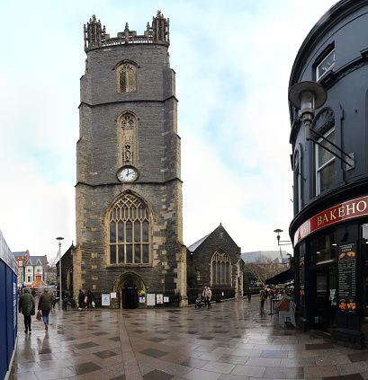 Cardiff, United Kingdom - December 01, 2018: The 15th century Saint John The Baptist Church and bell tower in a cloudy winter day after rain in Cardiff, United Kingdom