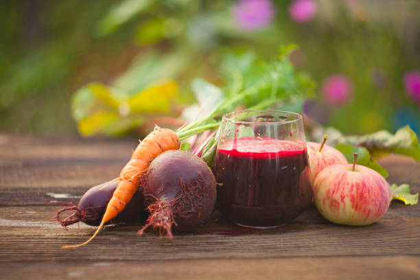 beet juice in glass on  table stock photo