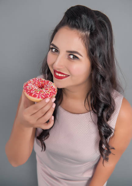 istock Happy plus size woman with donut. Overweight concept 1080827926