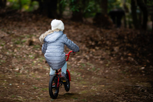istock Girl riding a bicycle in the woods 1080846252