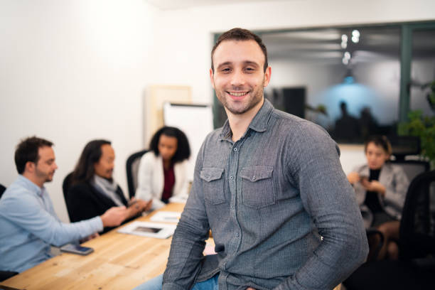 istock Smiling Caucasian man with a business team 1080851990