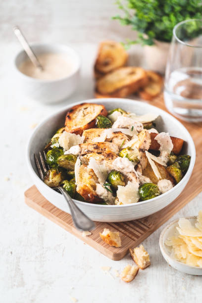 caesar salad with brussels sprouts, parmesan, grilled chicken and croutons - salad food and drink food lettuce imagens e fotografias de stock