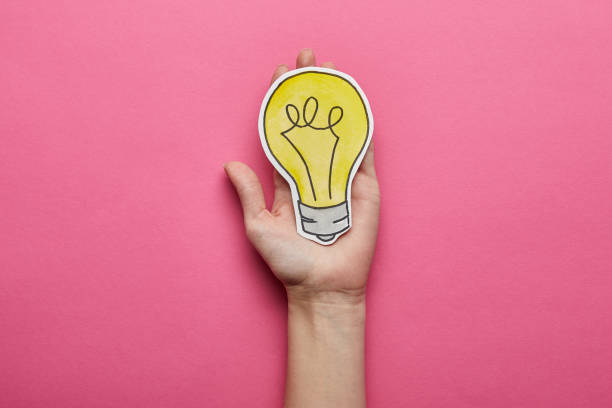 istock top view of yellow light bulb idea symbol on pink background 1080859082