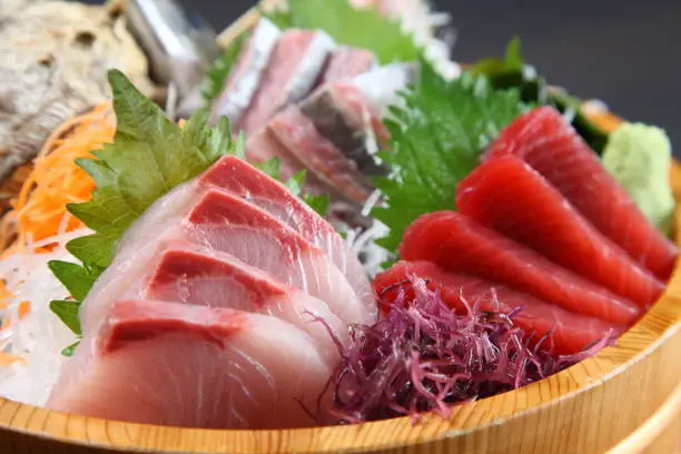 studio shot of fresh sashimi combo in a tub
