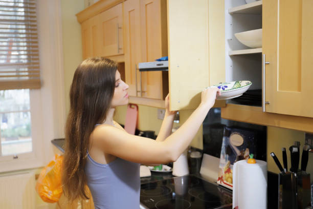 istock Opening a kitchen cupboard beautiful Russian indoor girl 1080871056