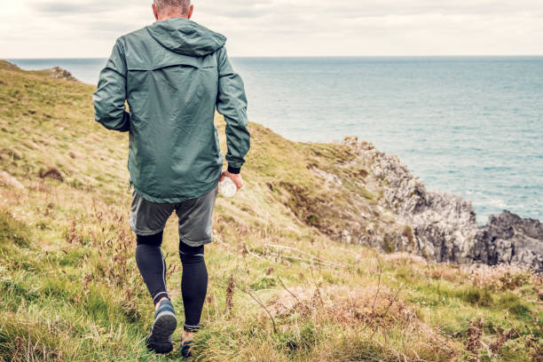 istock Man trail running along the rugged Cornish coastline on an Autumn day. 1080872556