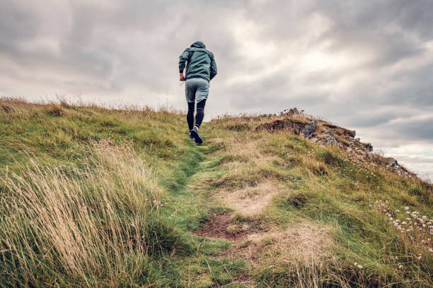 istock Man trail running along the rugged Cornish coastline on an Autumn day. 1080872636