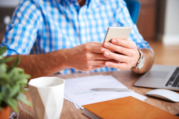 istock Close up of man's hands using mobile phone 1080873408